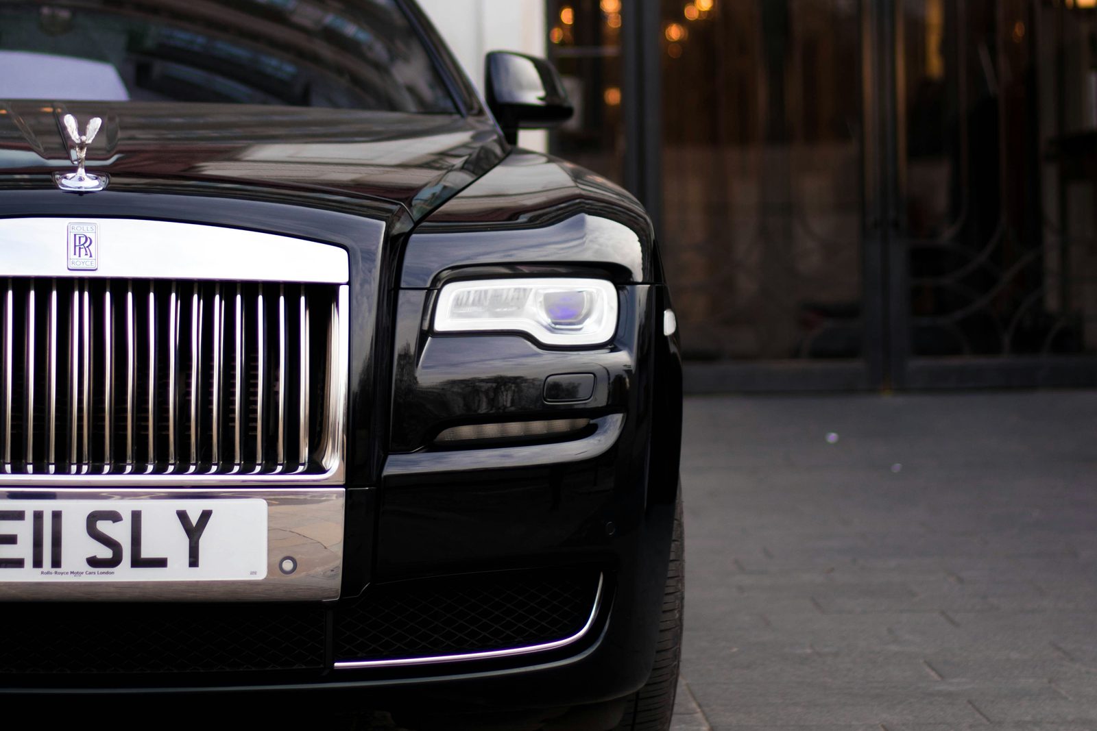 A Rolls-Royce waiting at a hotel portico